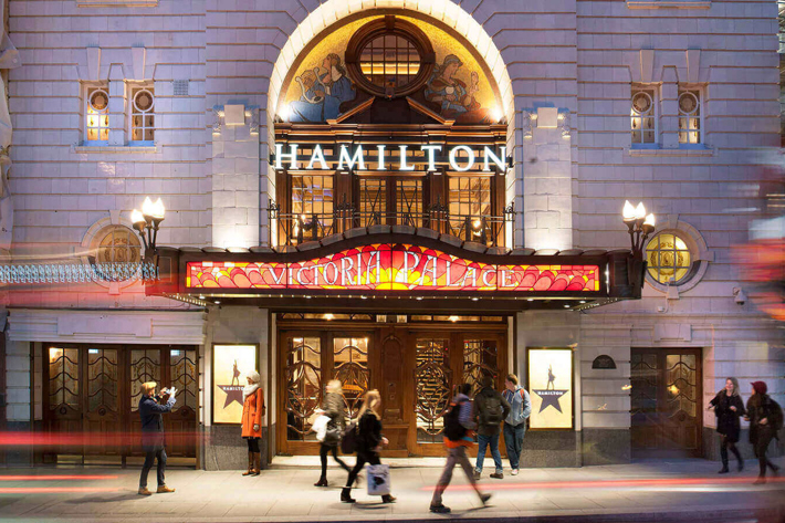 Front of Victoria Palace Theatre with Hamilton advertisements