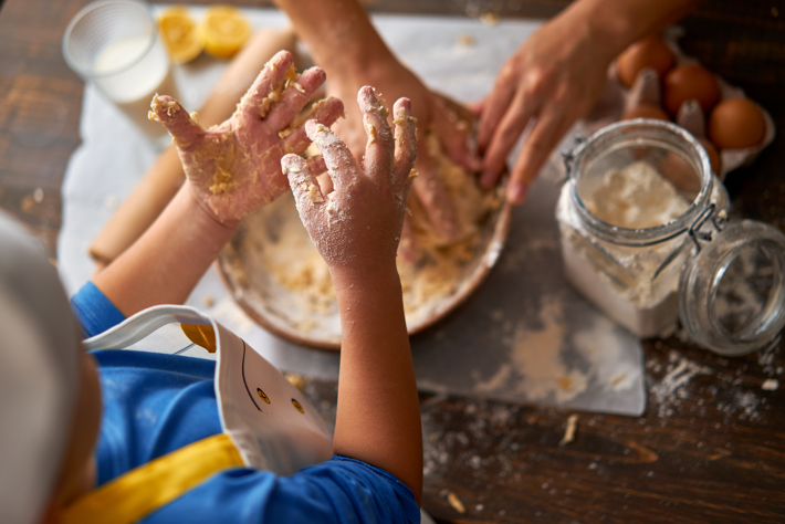 child making dough with messy hands